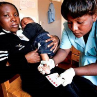 Nurse with mother and baby